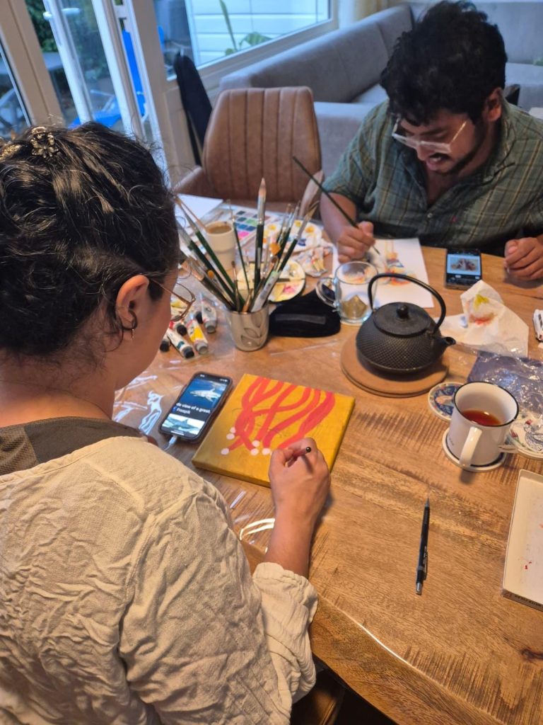 Artist painting one of the canvases during the creation of the acrylic ocean triptych Vertical Journey Through the Ocean.