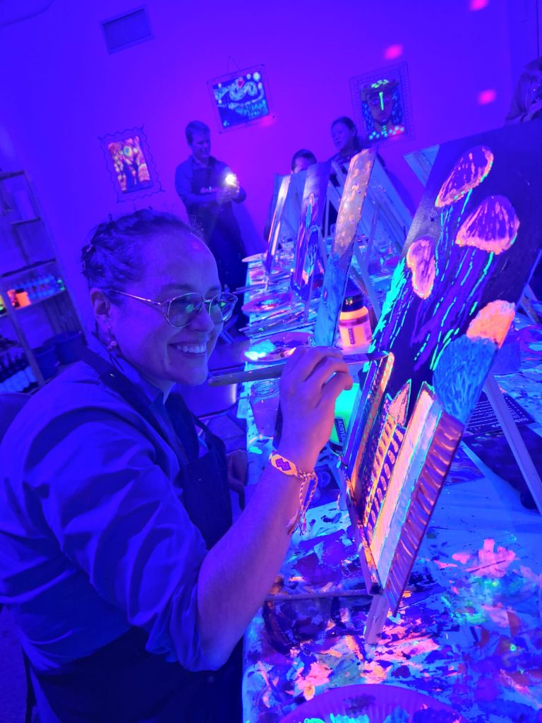 Elsa Quicazán painting "Without the Ocean, There Is No City" during its creation.