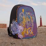 Acrylic-painted suitcase featuring a colorful octopus with the Scheveningen lighthouse in the background.