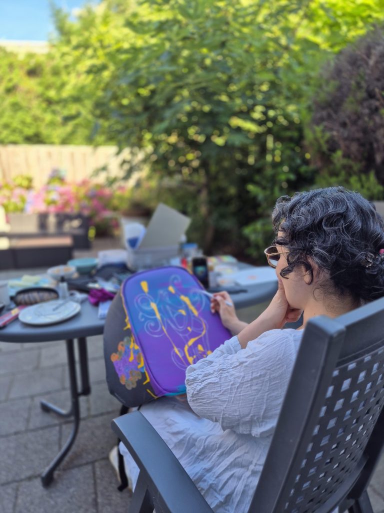 Beginning the acrylic painting process on the suitcase.